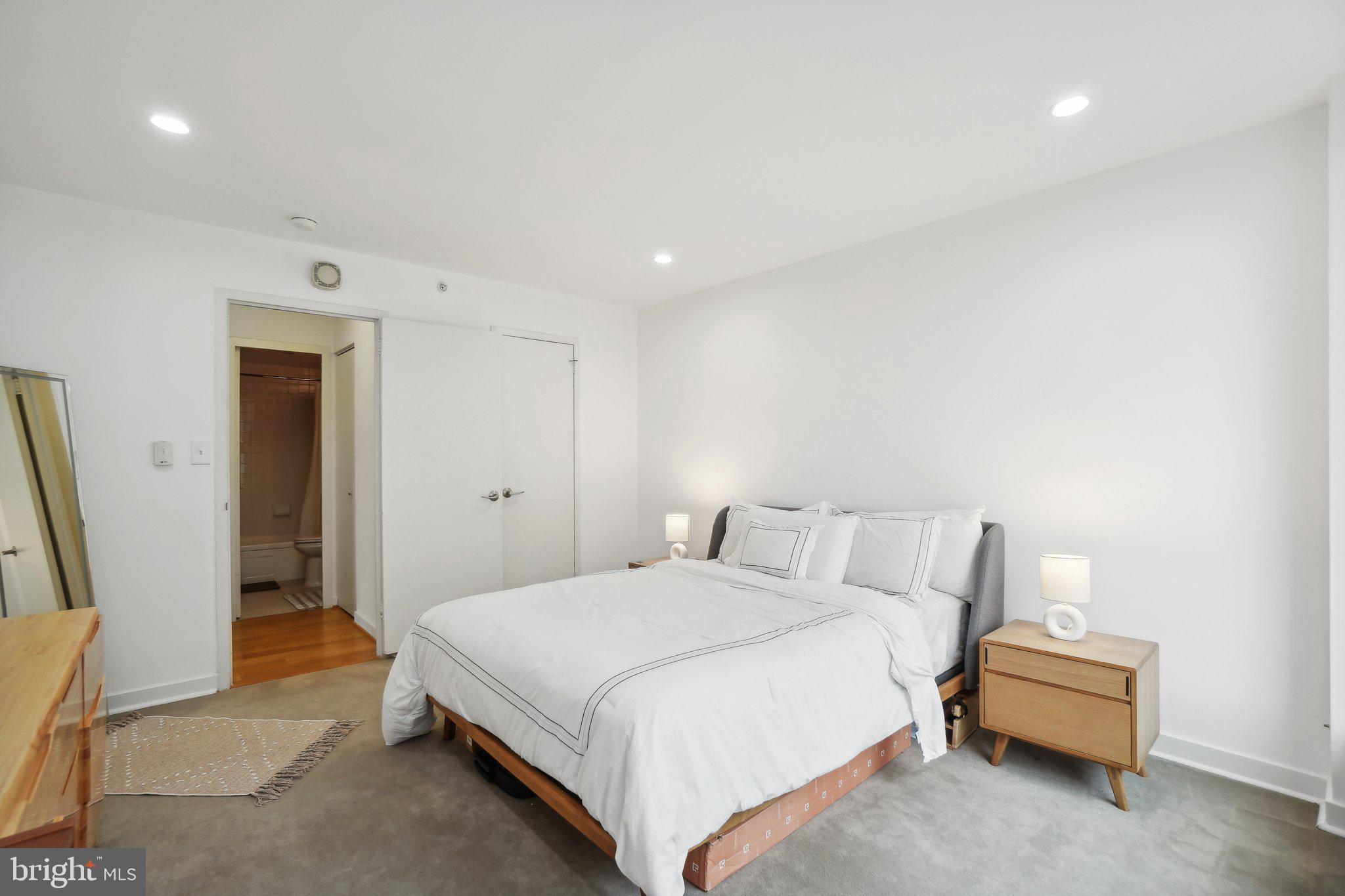 1101 3rd Street Southwest, Unit 706 Washington, DC 20024 - Photo 19 of 26 a bedroom with a bed and a chair