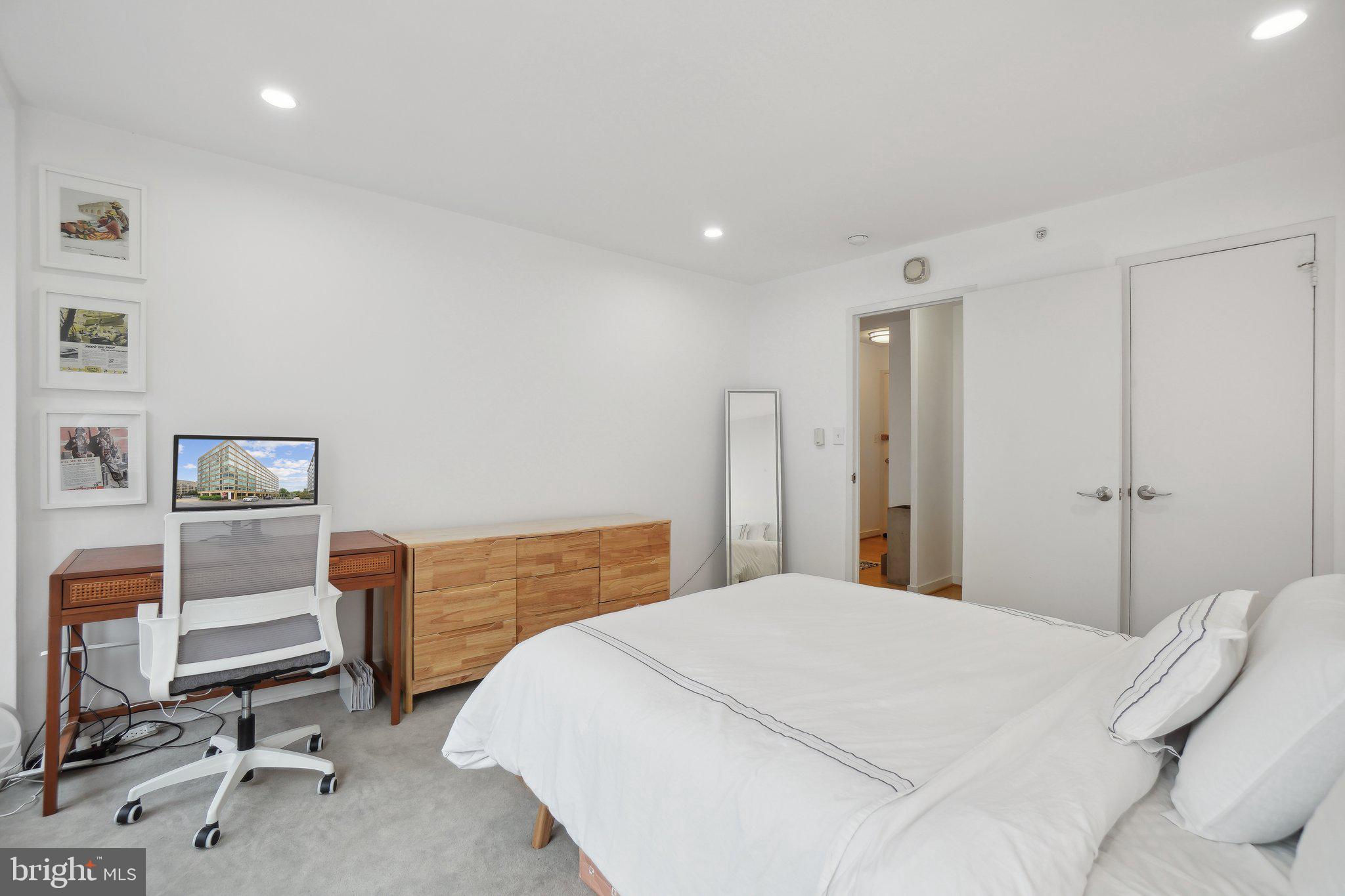 1101 3rd Street Southwest, Unit 706 Washington, DC 20024 - Photo 20 of 26 a bedroom with a bed and gym equipment