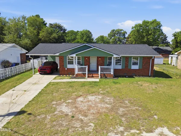a front view of a house with a garden and porch