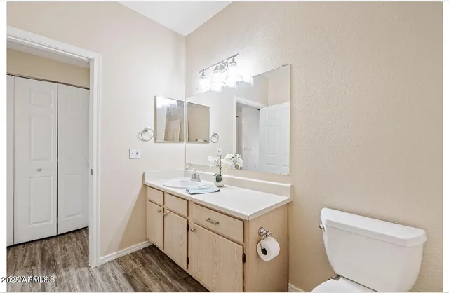 a spacious bathroom with a toilet sink and mirror