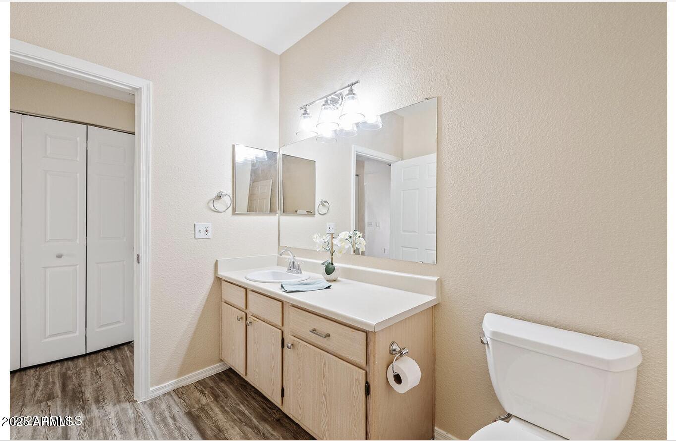 3236 East Chandler Boulevard, Unit 1079 Phoenix, AZ 85048 - Photo 11 of 17 a spacious bathroom with a toilet sink and mirror