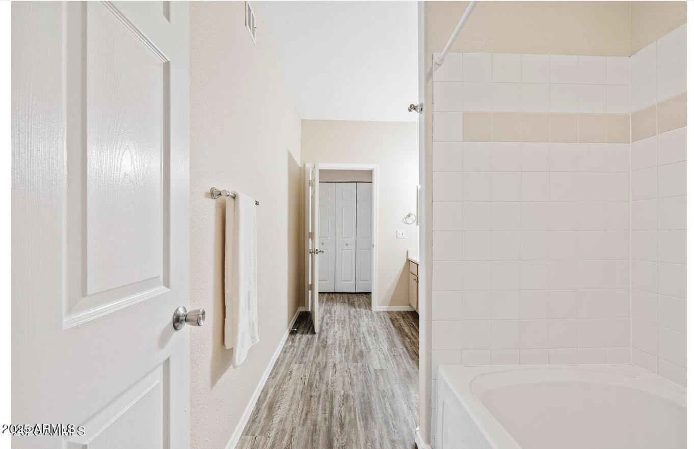 3236 East Chandler Boulevard, Unit 1079 Phoenix, AZ 85048 - Photo 13 of 17 a view of a bedroom from a hallway