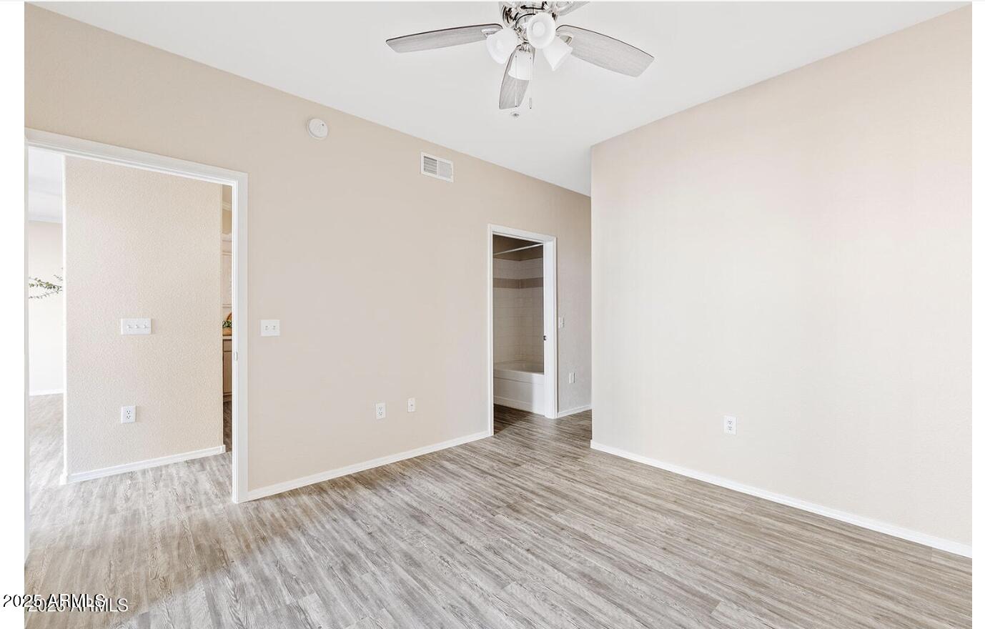 3236 East Chandler Boulevard, Unit 1079 Phoenix, AZ 85048 - Photo 14 of 17 a view of an empty room with wooden floor