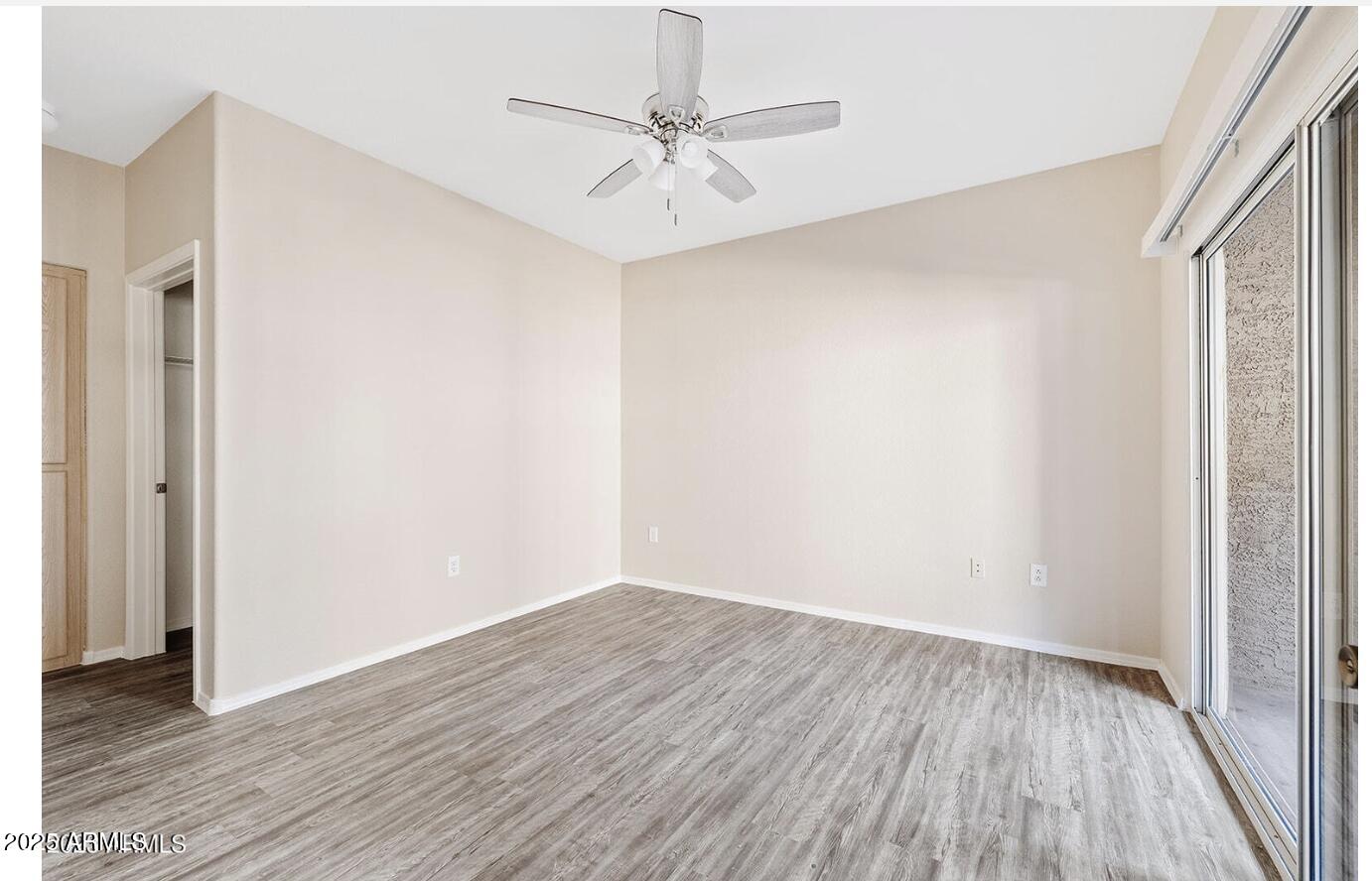 3236 East Chandler Boulevard, Unit 1079 Phoenix, AZ 85048 - Photo 15 of 17 a view of a room with wooden floor and a ceiling fan
