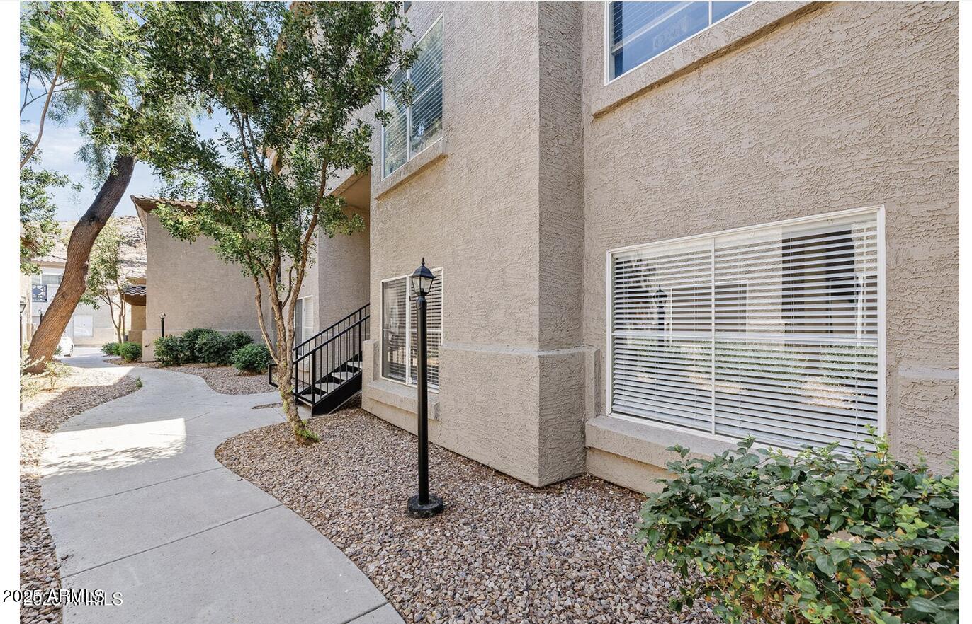 3236 East Chandler Boulevard, Unit 1079 Phoenix, AZ 85048 - Photo 17 of 17 a view of a house with backyard and a tree