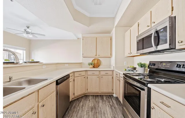 a kitchen with stainless steel appliances cabinets a sink and a stove