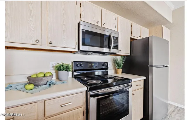 a kitchen with stainless steel appliances white cabinets and a stove