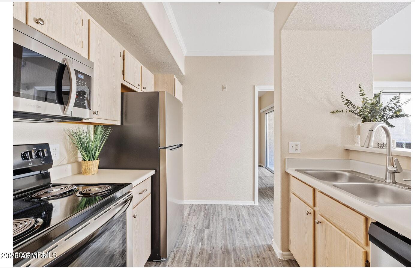 3236 East Chandler Boulevard, Unit 1079 Phoenix, AZ 85048 - Photo 5 of 17 a kitchen with stainless steel appliances granite countertop a sink stove and refrigerator