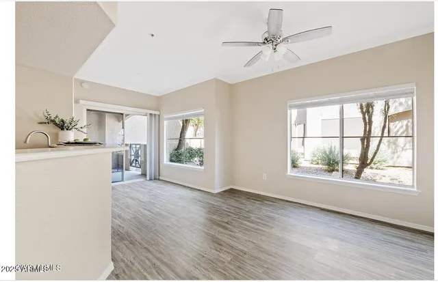 a room with a window and a kitchen view