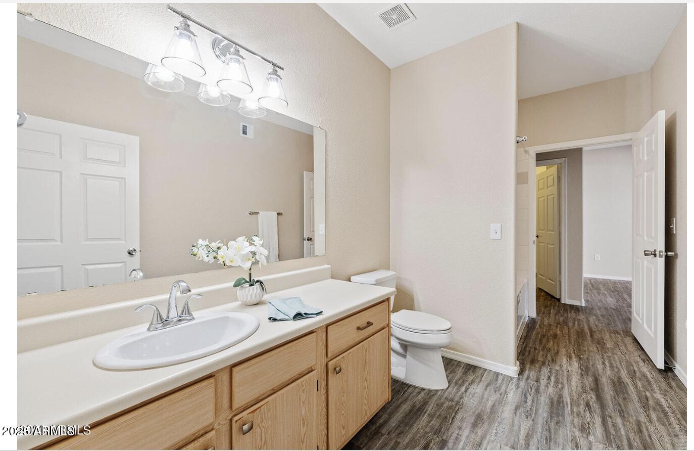 3236 East Chandler Boulevard, Unit 1079 Phoenix, AZ 85048 - Photo 10 of 17 a bathroom with a sink a toilet and a large mirror