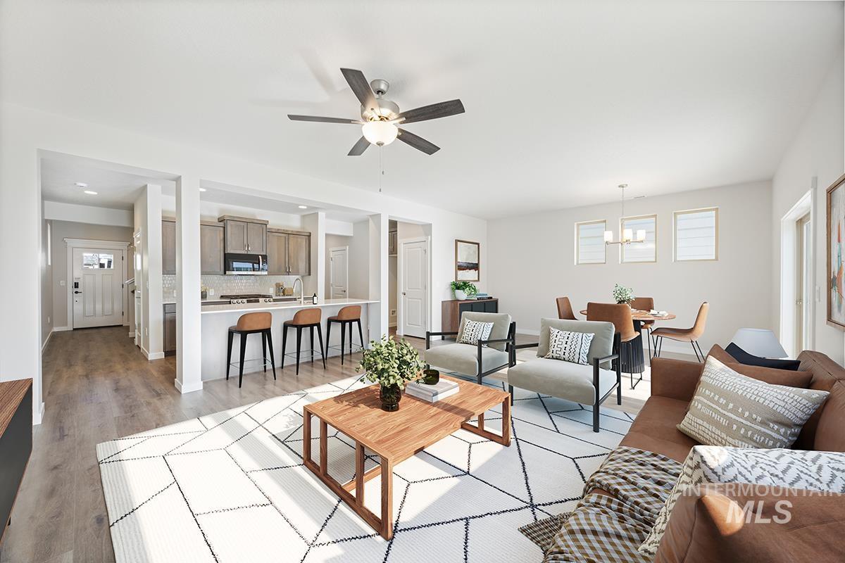 205 West Broyhill Street Meridian, ID 83642 - Photo 5 of 20 Living room with a ceiling fan, light wood-style floors, and suspended lighting