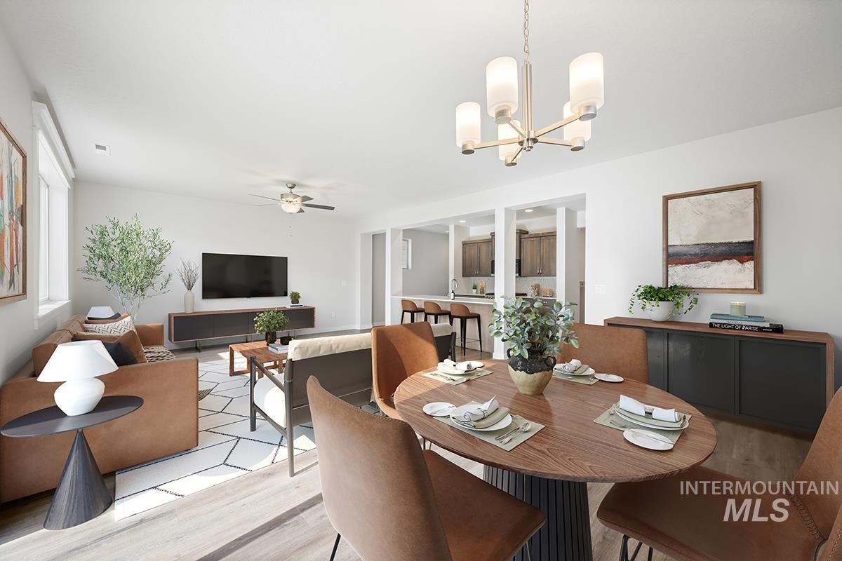 205 West Broyhill Street Meridian, ID 83642 - Photo 6 of 20 Dining space with wood finished floors, a ceiling fan, and suspended lighting
