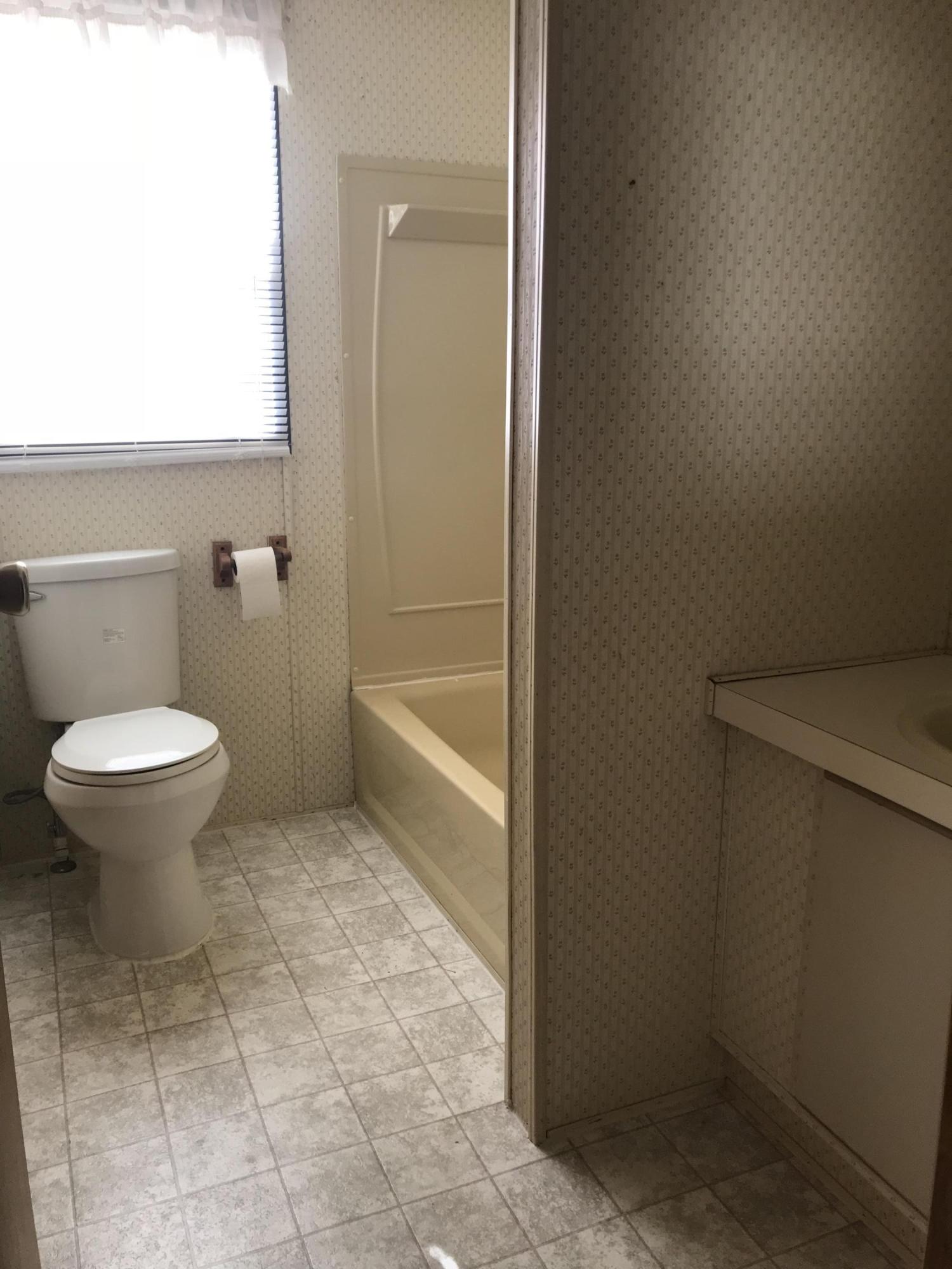 2321 Navigation Point Goodview, VA 24095 - Photo 14 of 26 a bathroom with a toilet and a bath tub