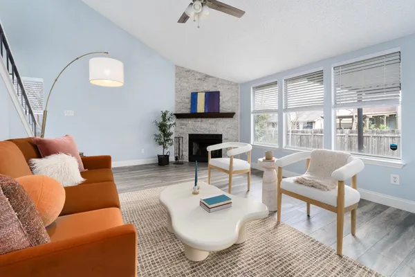 a living room with furniture and a fireplace