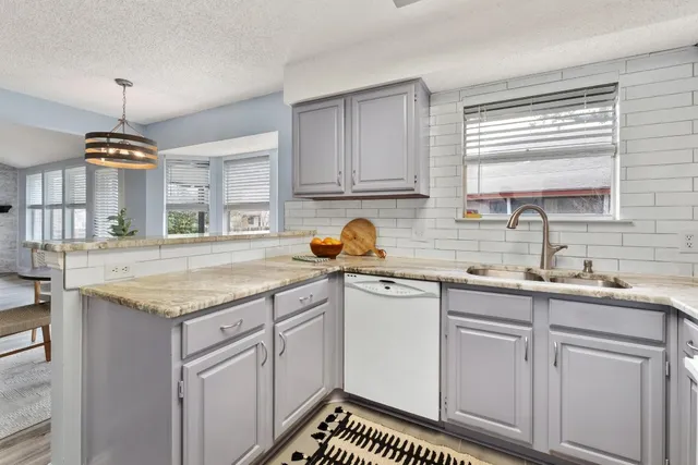 a kitchen with a sink stove and cabinets