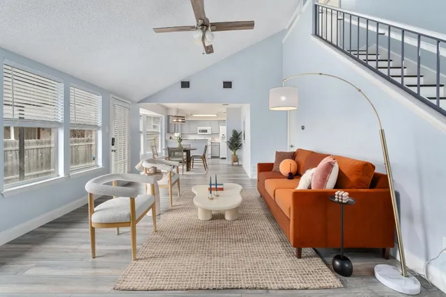 a living room with furniture and wooden floor