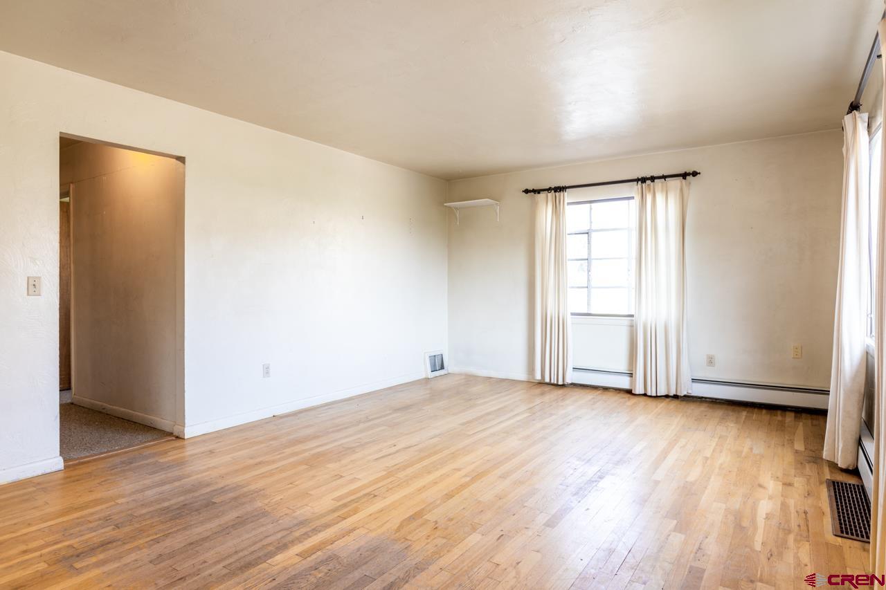 706 39 Road Palisade, CO 81526 - Photo 16 of 35 an empty room with wooden floor and windows