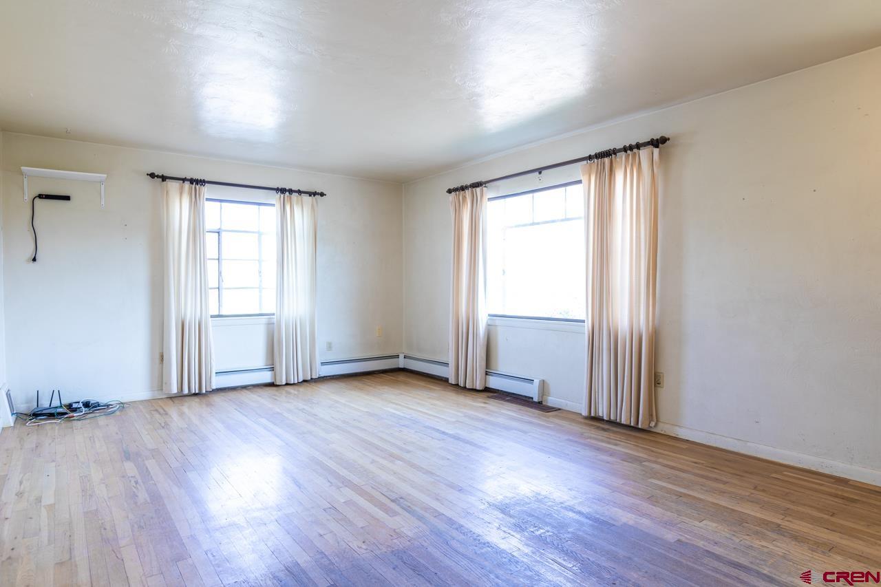 706 39 Road Palisade, CO 81526 - Photo 17 of 35 an empty room with wooden floor and windows