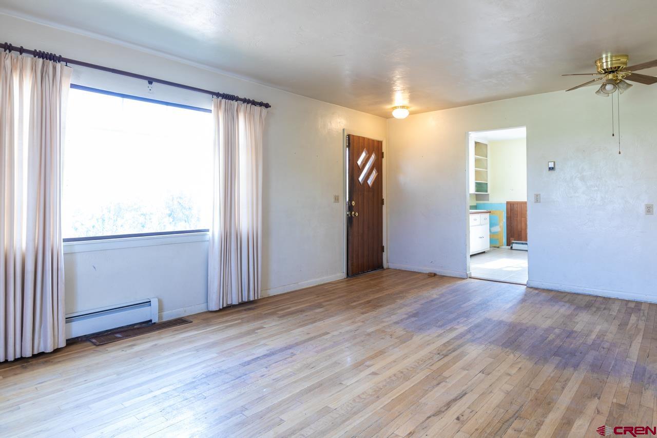 706 39 Road Palisade, CO 81526 - Photo 18 of 35 an empty room with wooden floor and windows