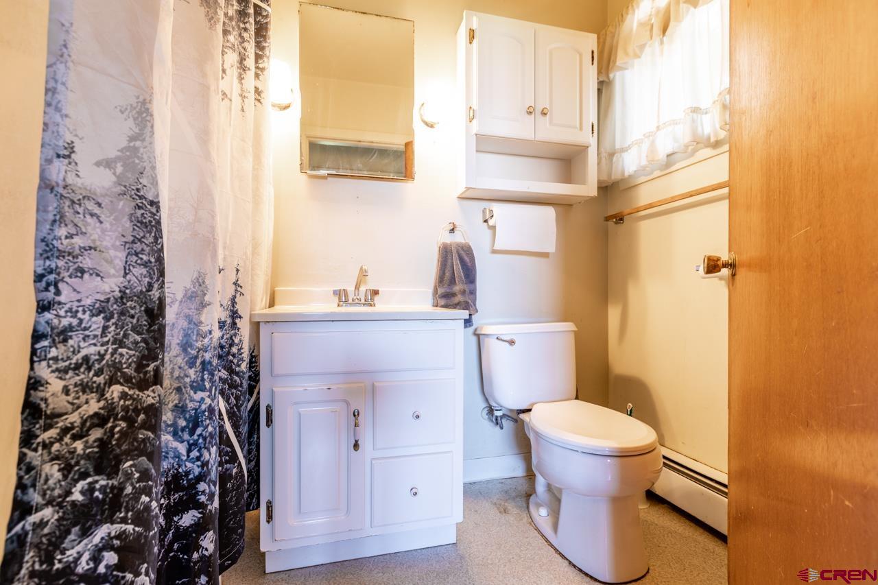 706 39 Road Palisade, CO 81526 - Photo 8 of 35 a bathroom with a granite countertop toilet and a sink