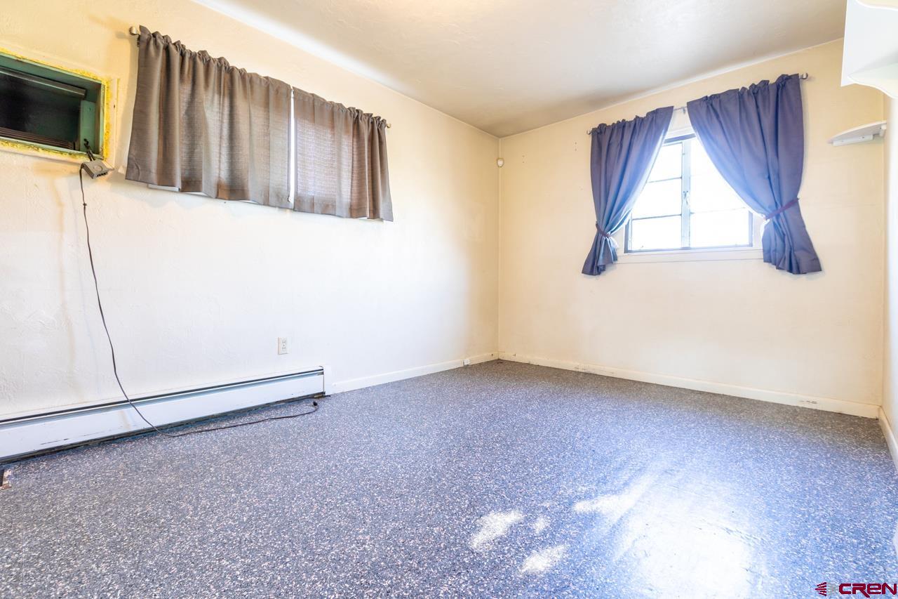 706 39 Road Palisade, CO 81526 - Photo 10 of 35 a view of an empty room with a window and wooden floor