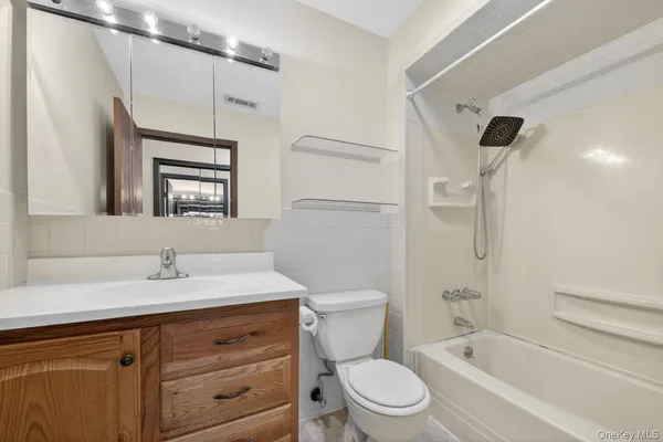 a bathroom with a sink toilet vanity and shower