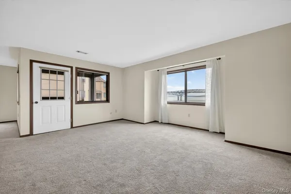 an empty room with windows and closet