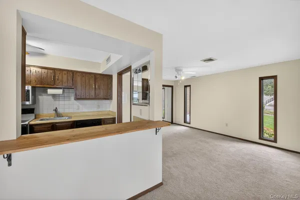 a view of kitchen with refrigerator and window
