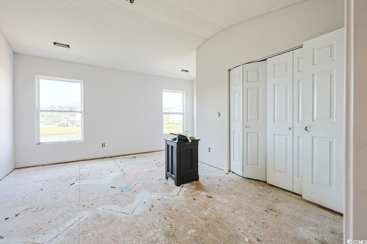 308 Kiskadee Loop, Unit E Conway, SC 29526 - Photo 11 of 28 Unfurnished bedroom featuring a textured ceiling and a closet