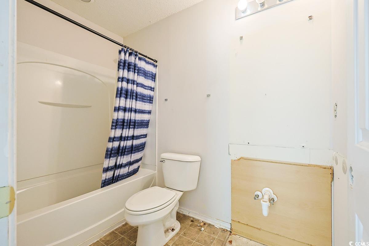 308 Kiskadee Loop, Unit E Conway, SC 29526 - Photo 18 of 28 Full bathroom with shower / bathtub combination with curtain, tile patterned floors, and a textured ceiling