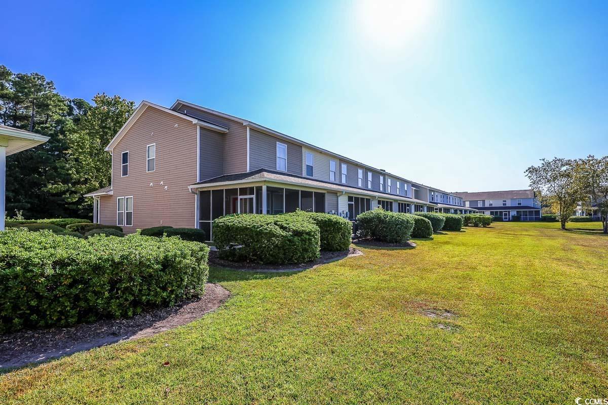 308 Kiskadee Loop, Unit E Conway, SC 29526 - Photo 25 of 28 Back of house with a lawn and a sunroom
