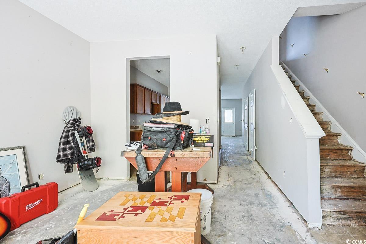 308 Kiskadee Loop, Unit E Conway, SC 29526 - Photo 4 of 28 Living area featuring unfinished concrete flooring and stairway