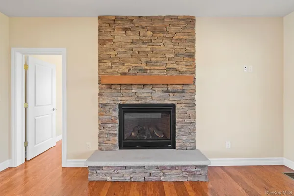 a living room with a fireplace and a wooden floor