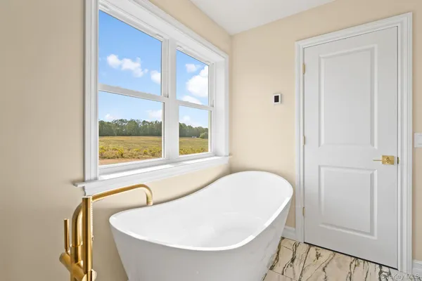 a bathroom with a tub and a window