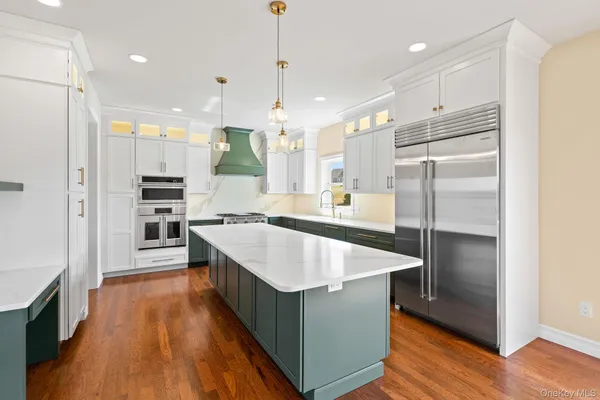 a large kitchen with stainless steel appliances kitchen island granite countertop a large counter top and stainless steel appliances