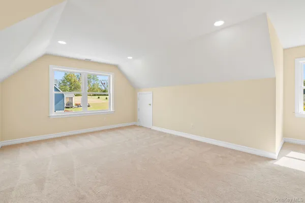 an empty room with windows and painted walls