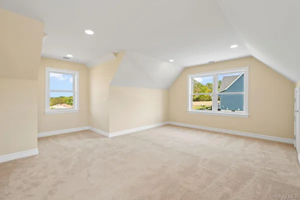 an empty room with windows and mirror