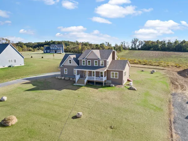 an aerial view of a house with big yard