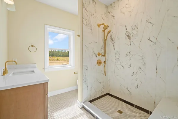 a bathroom with a sink a window and a shower