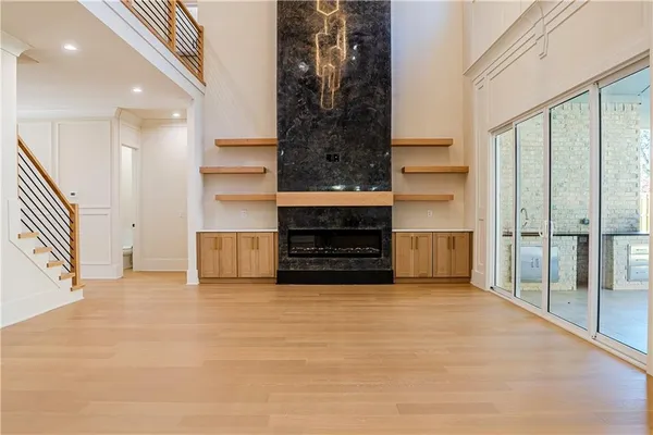 a view of an empty room with a fireplace and a window
