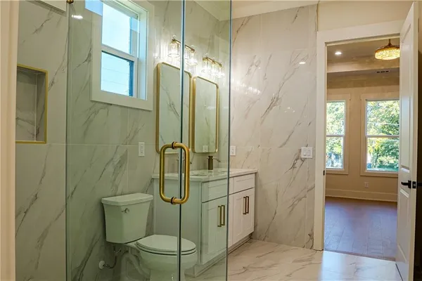 a bathroom with a sink toilet and shower