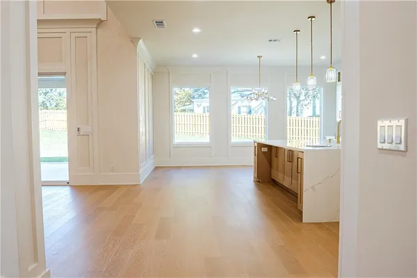 a view of an empty room with glass door and windows