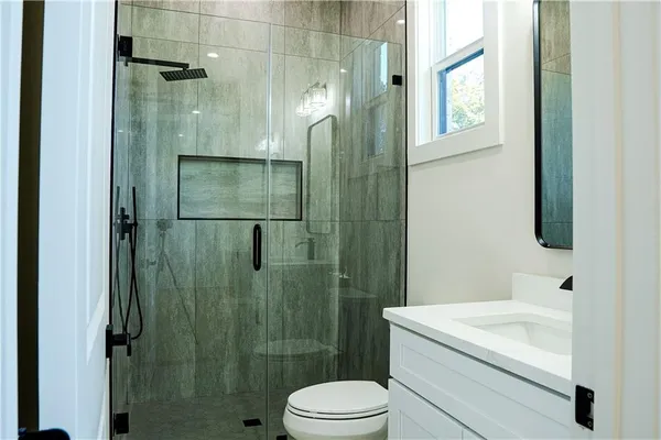 a view of a white house with wooden fence