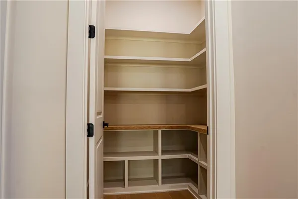 a view of walk in closet with empty racks