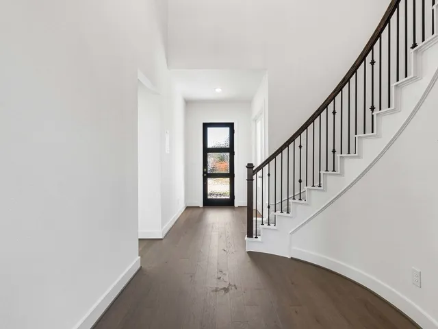 a view of kitchen with kitchen island sink and refrigerator