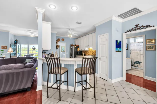 a living room with furniture and kitchen view