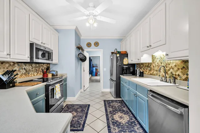 a spacious bedroom with a bed and a chandelier