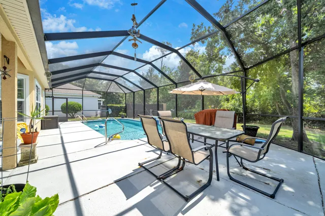 a view of a backyard with swimming pool