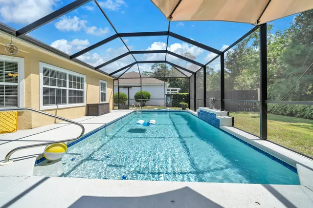 a view of a backyard with couches and a large tree