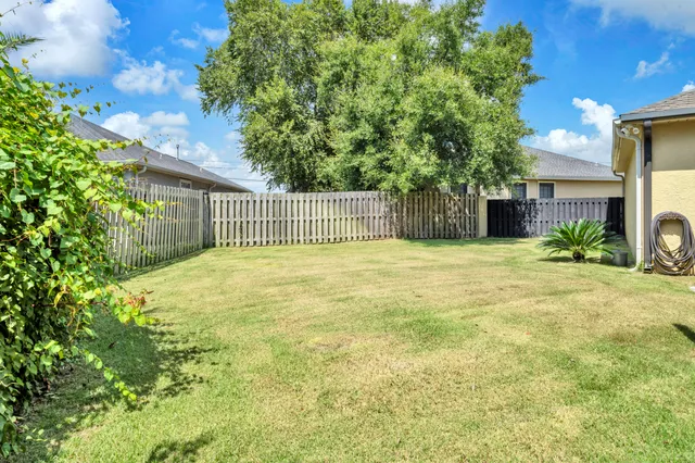 a front view of a house with a garden and plants